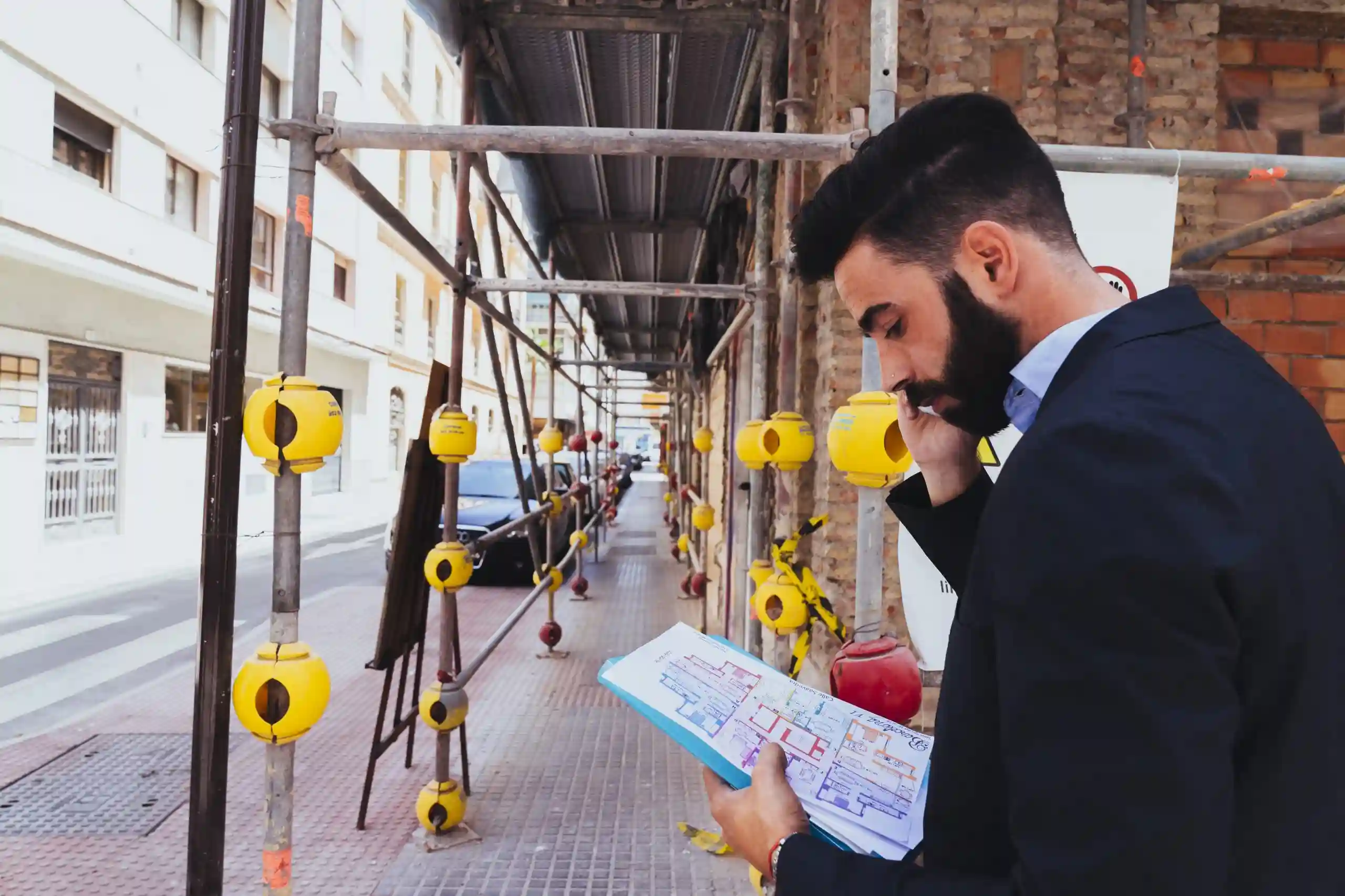 young-businessman-working-talking-phone-scaled