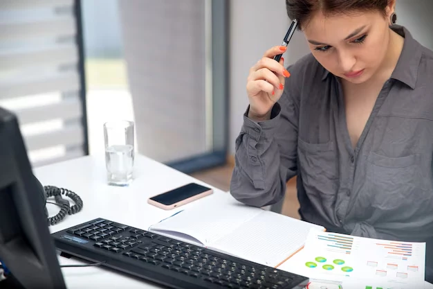 front-view-young-businesswoman-working-her-pc-table-along-with-phone-graphics-writing-down-notes-thinking-job-activities-technology_140725-15298