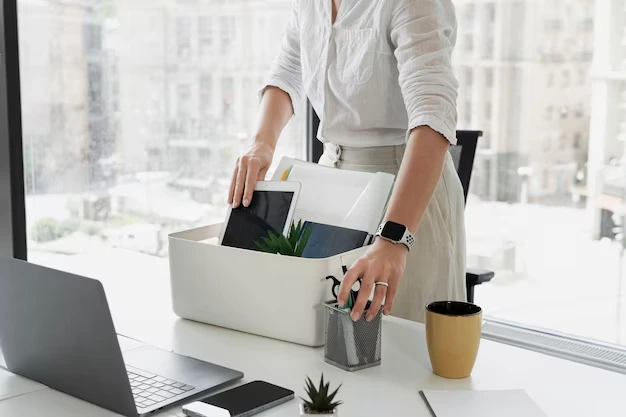 side-view-woman-packing-desk-items_